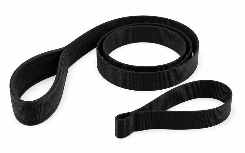 Illustration of a black leg lifter strap with a hand loop and a foot loop.