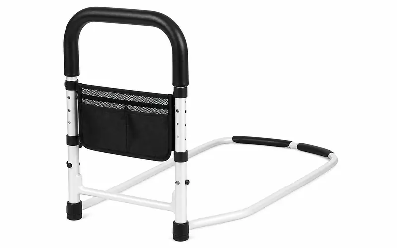 Illustration of a height-adjustable bed assist rail with a padded handle and storage pouch. Shows the type of product, not the exact brand or model.