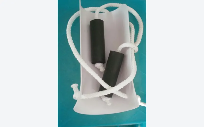 Photo of a white sock aid with long cord handles.